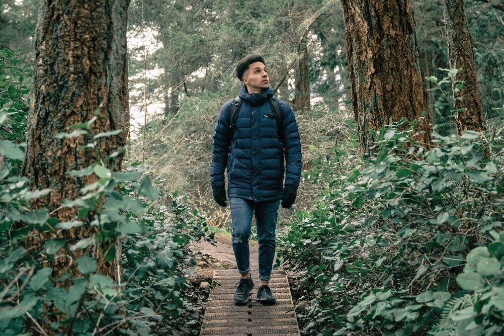 Person walking on trail through forest