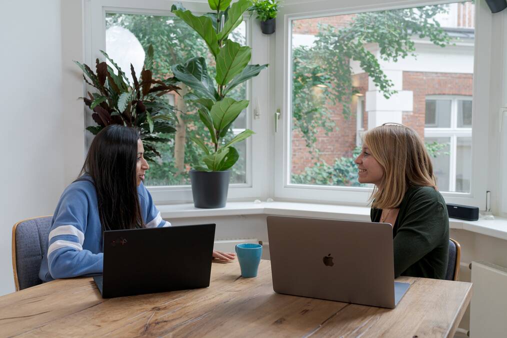 A student sitting at a table with a study abroad program coordinator