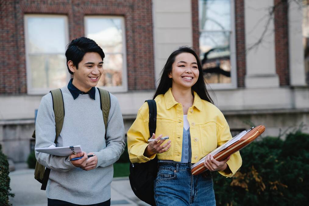 Two students walking through campus