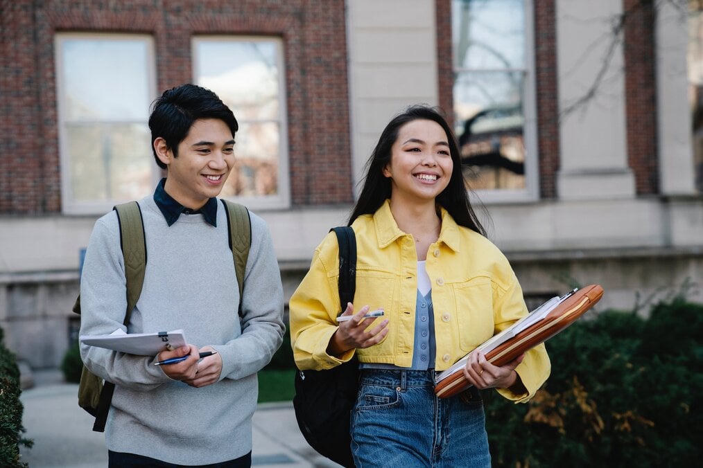 Image courtesy of George Pak, Pexels Two students walking through campus