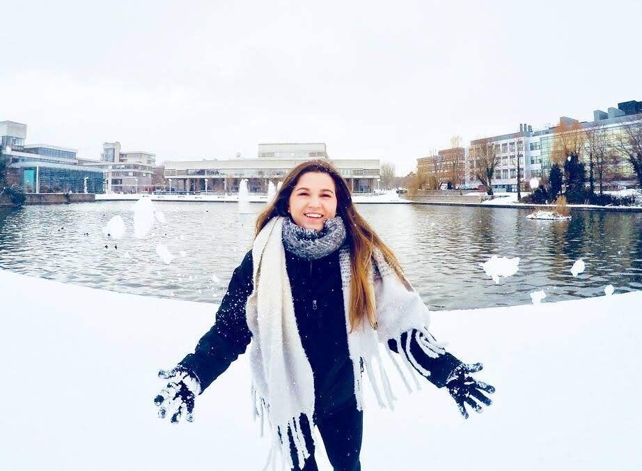 Kendra, University College Dublin alum Study abroad student throwing snow at the camera