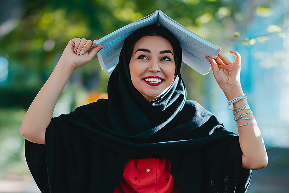 Student with book on her head