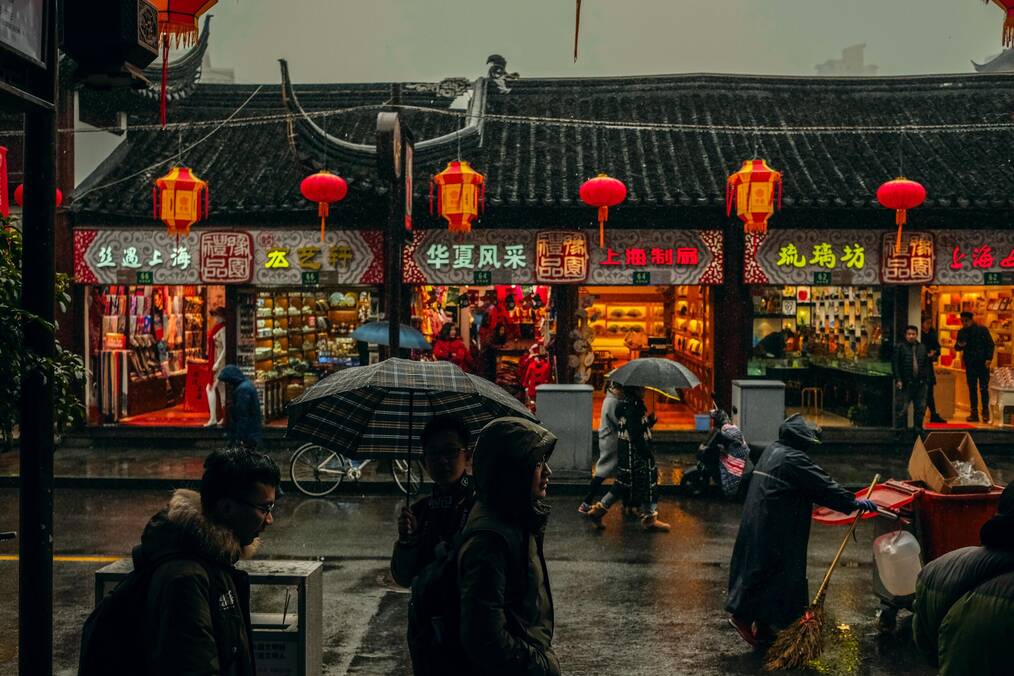 A busy Chinese city street at night.