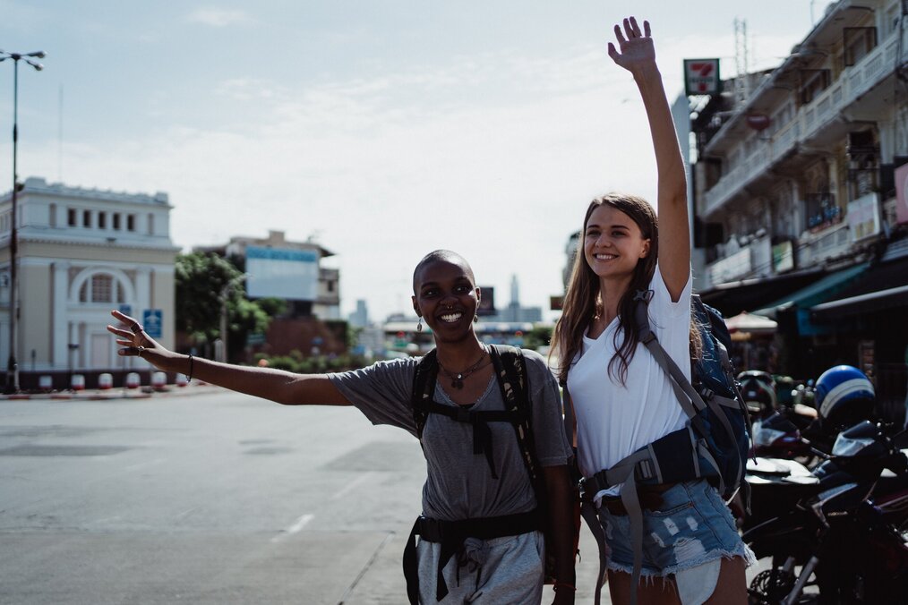 Image curtsey of Ketut Subiyanto, Pexels two backpackers hailing a cab