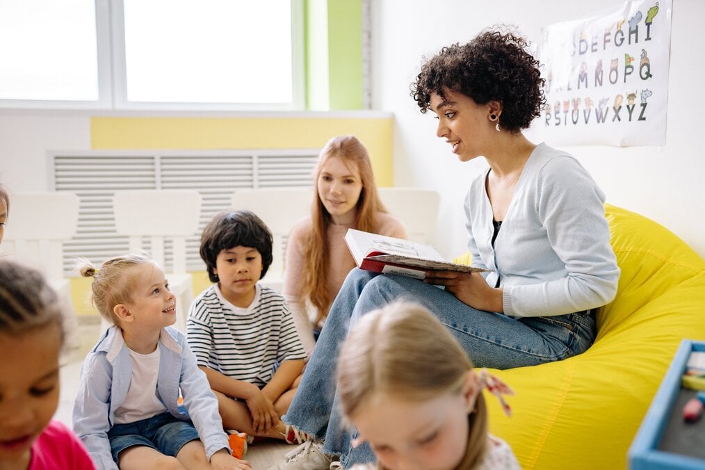 Photo by Yan Krukov Woman reading to young children.