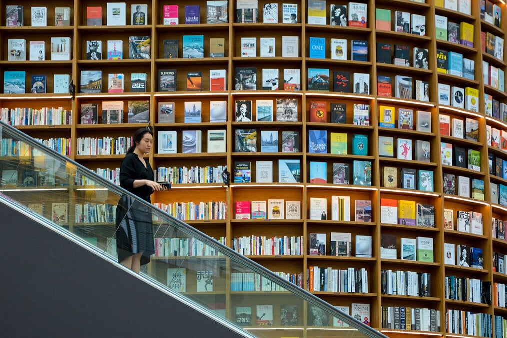 A person on a staircase of a library