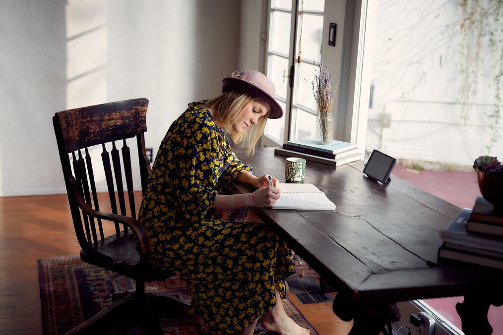 Image curtesy of Darium Bashar, Unsplash A digital nomad journalist sitting at her desk writing