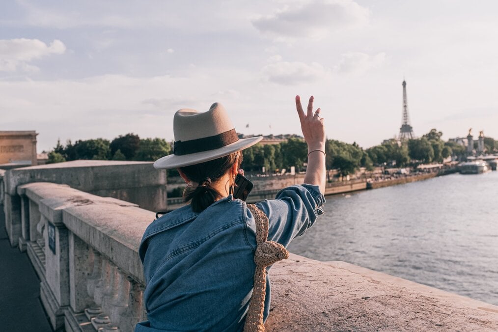 Photo by Daria Shevtsova on Pexels A woman with her back to the camera making a peace sign in the air.