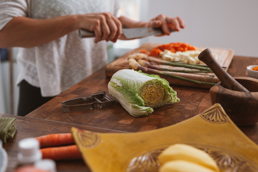 A person chopping vegetables