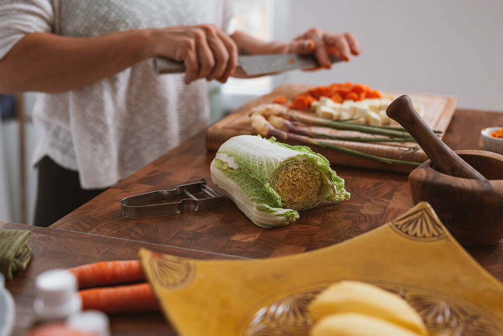 A person chopping vegetables 