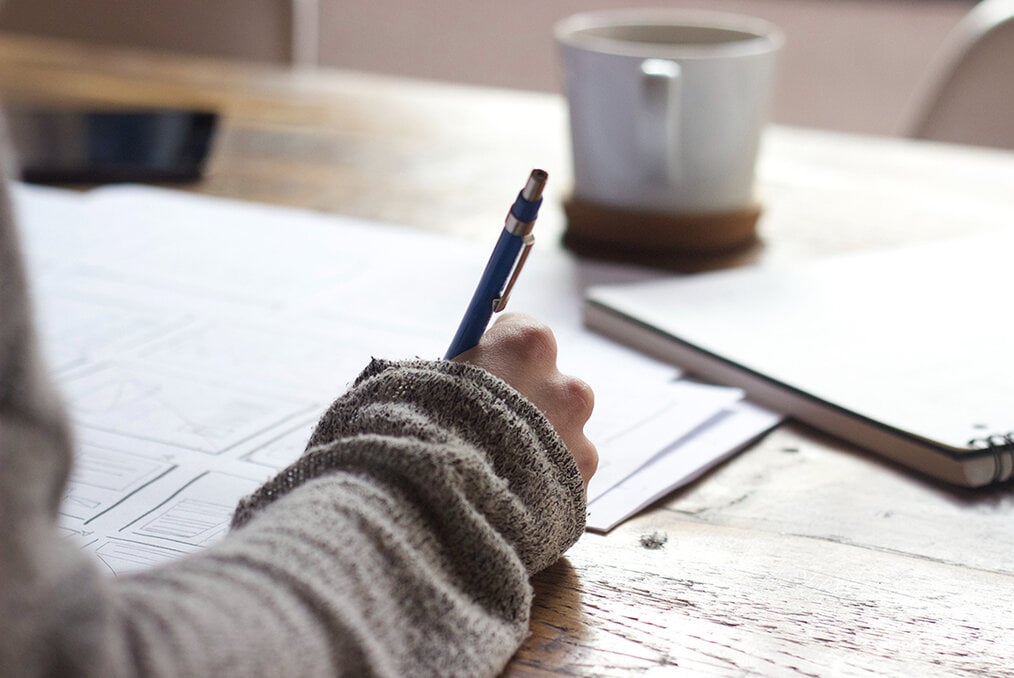A person writing an essay