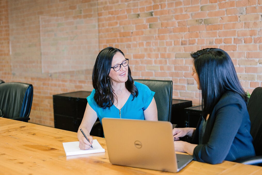 Two people sitting at a table in an interview