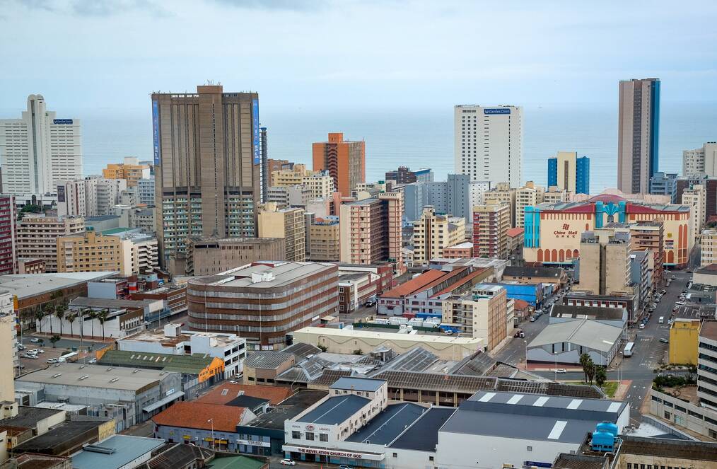 An aerial view and city landscape of the city of Durban with the ocean in the background