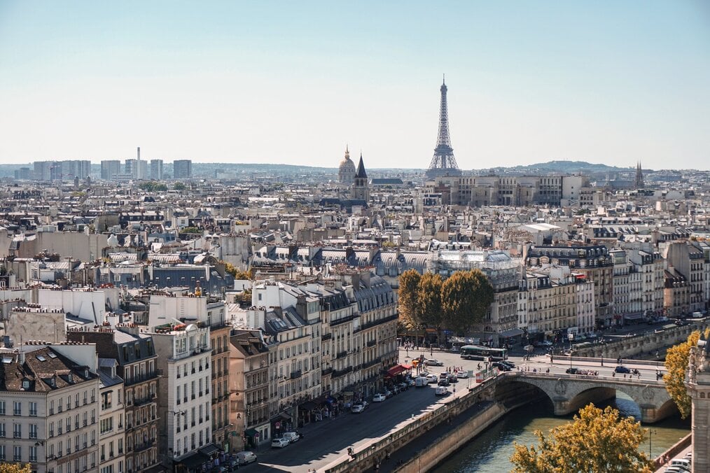 Photo by Alexander Kagan on Unsplash A city view of Paris with the Eiffel Tower in the background.