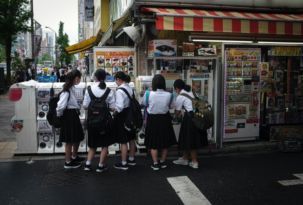 Photo by Hakan Nural on Unsplash Girls wearing school uniforms look at vending machine.