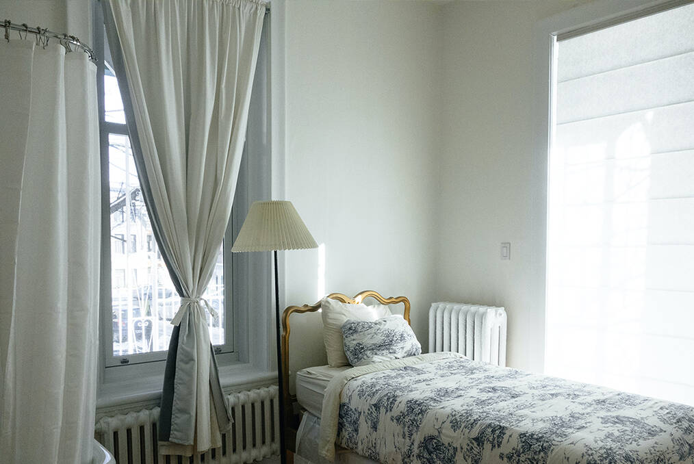 A small bed in the corner of a bedroom