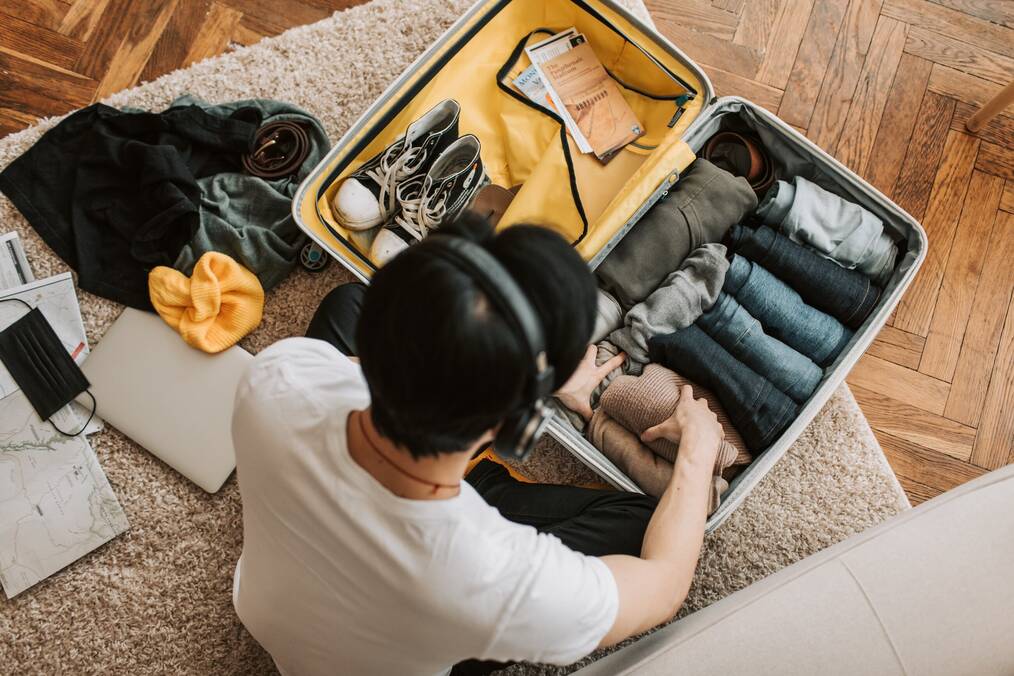 Person packing suitcase