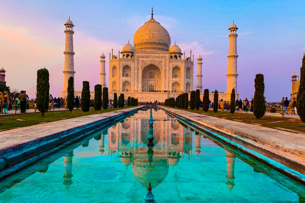 A teal, pink, and blue sunset behind the Taj Mahal