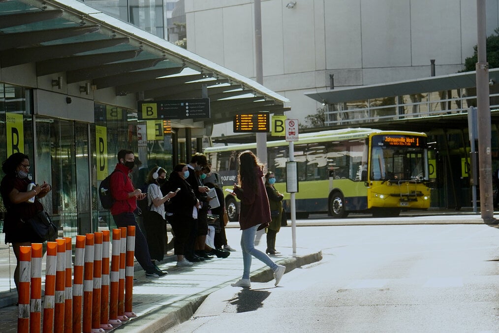 People waiting at a bus stop in Auckland, New Zealand