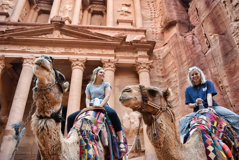 Two people riding camels