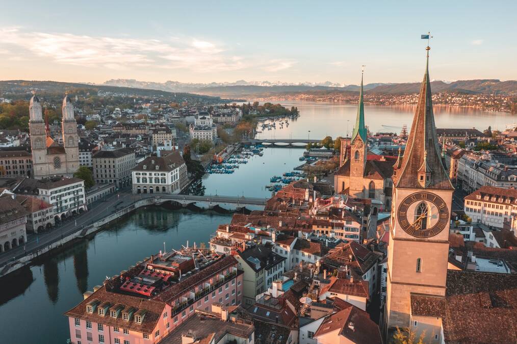 A cityscape view of the city of Zurich and the river that runs through the city 