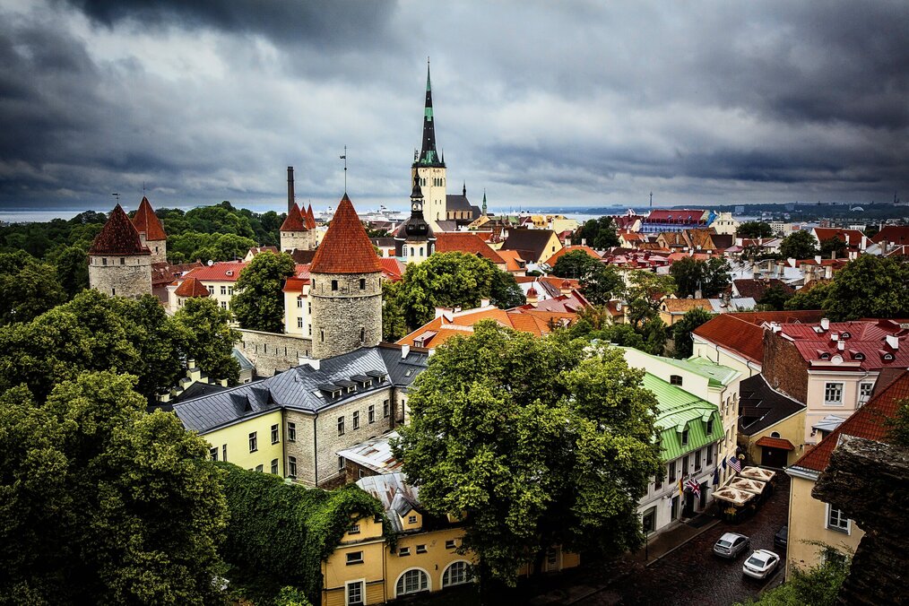 Photo by Leo Roomets on Unsplash A grey cloudy sky over historic buildings in Tallinn, Estonia.