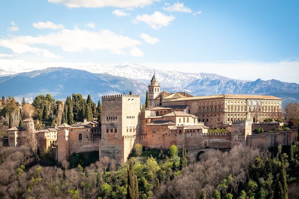 A castle with mountains in the background in Spain.