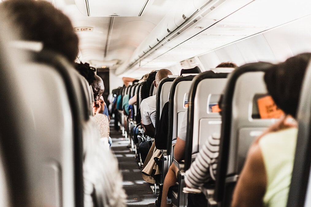 A photo down the middle row of a full passenger airplane