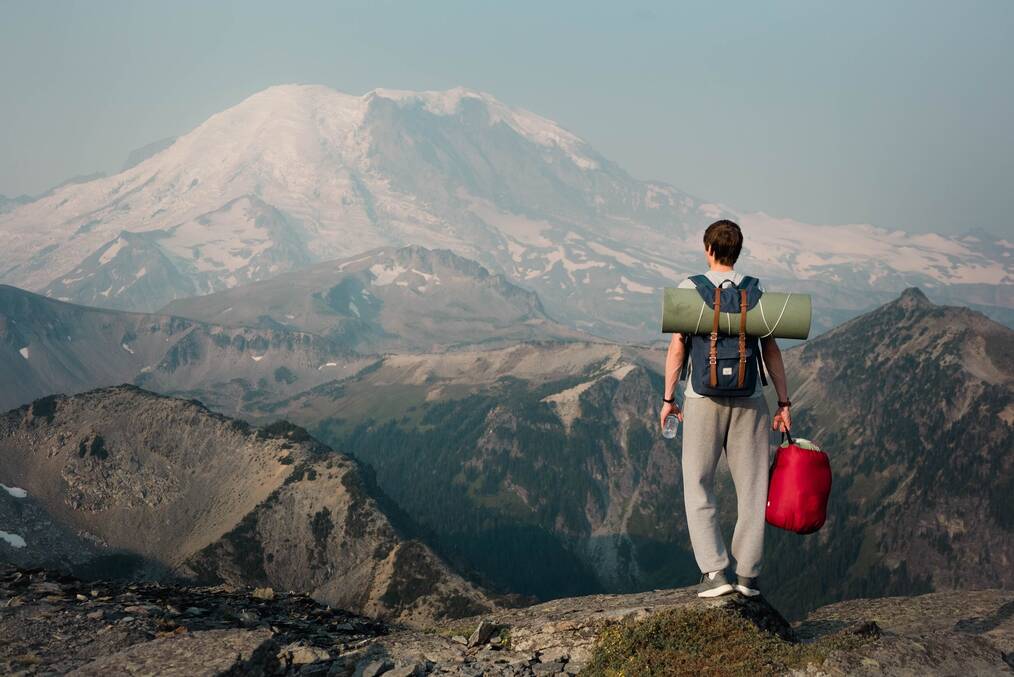 Backpacker standing on top of a mountain