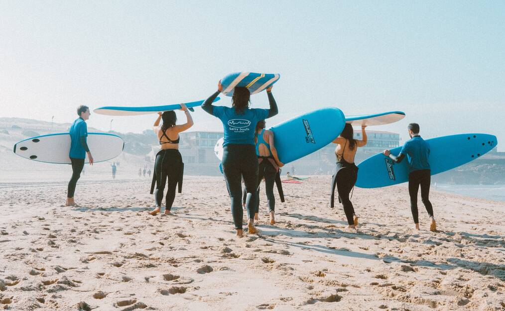 Group of surfboarders on beach