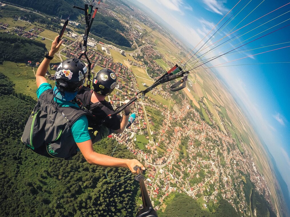 Photo by Vlad Hilitanu on Unsplash Two people parachuting above a city.
