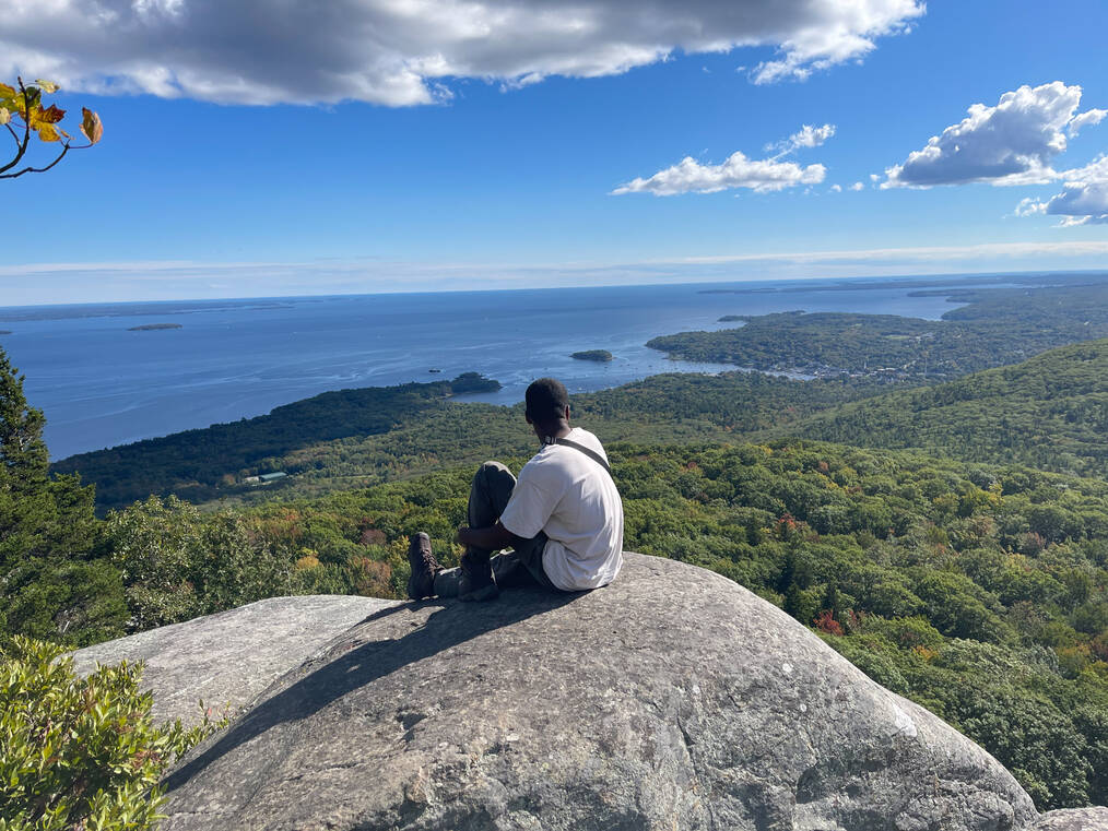 Maurice Sanders at the summit of a hike in Maine