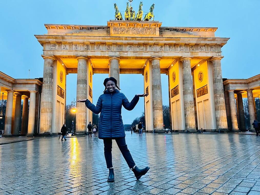 Avalon P standing in front of the  Brandenburg Gate in Berlin