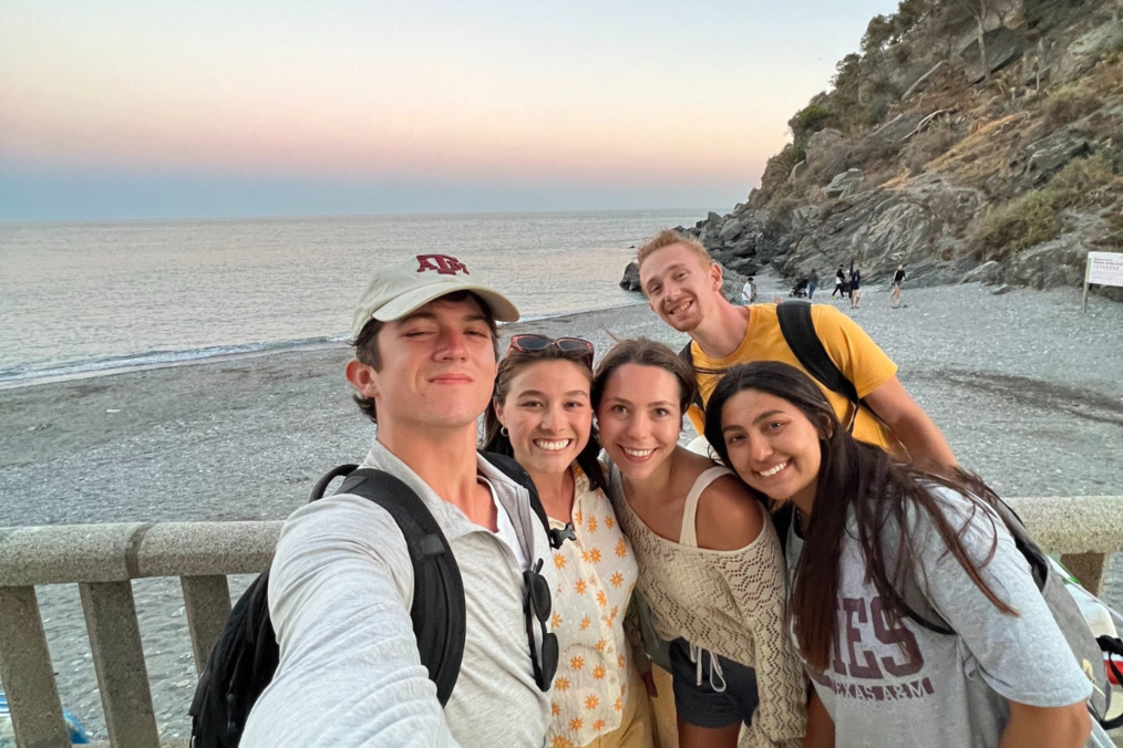 Sajin Poos smiling with a group of study abroad students