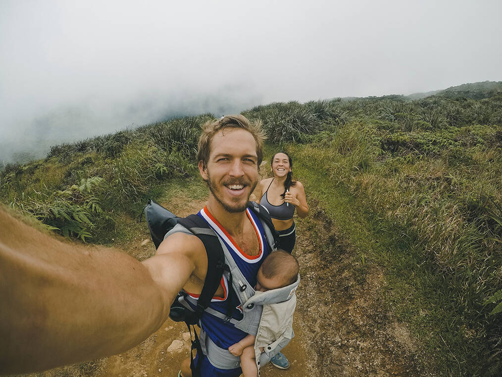 A couple hiking with a young child