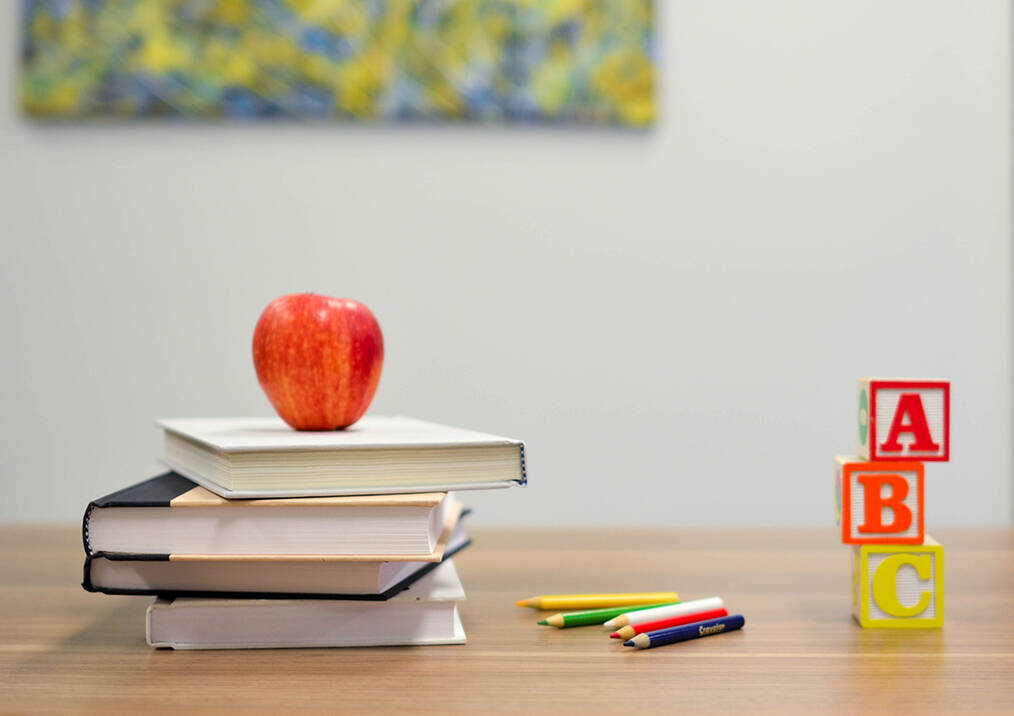 An apple sitting on a teachers desk
