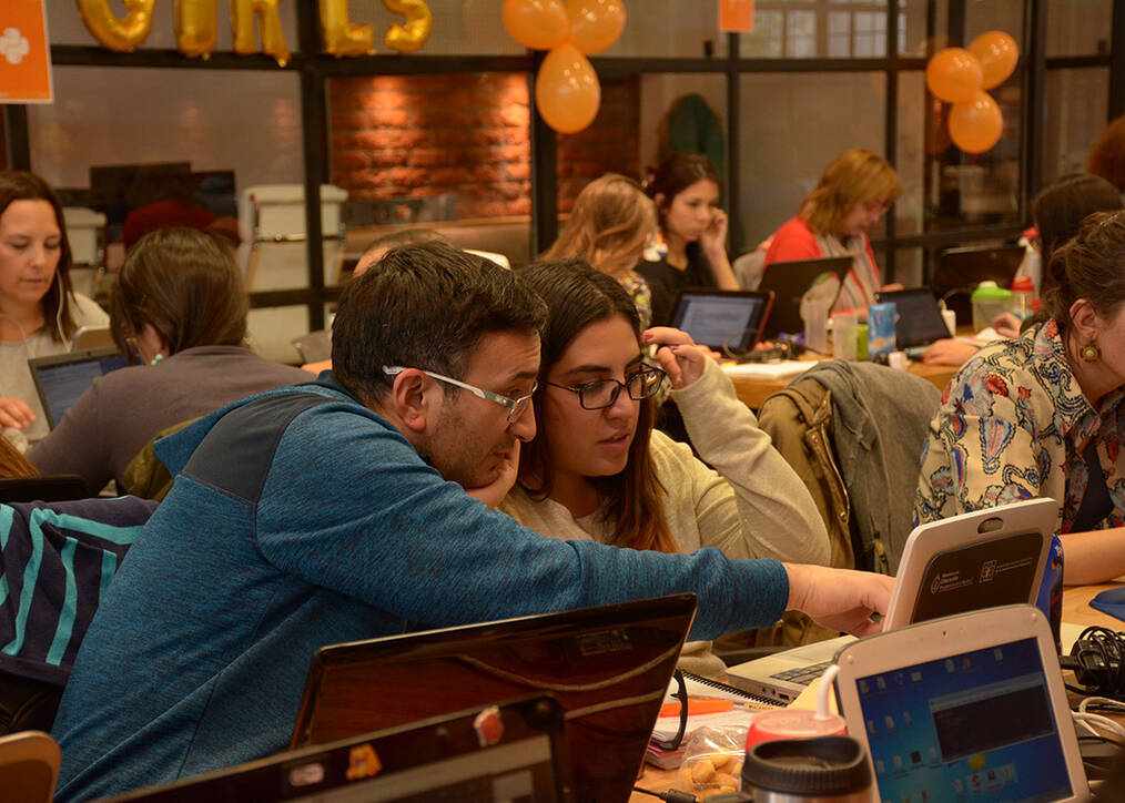 Two people working on a computer