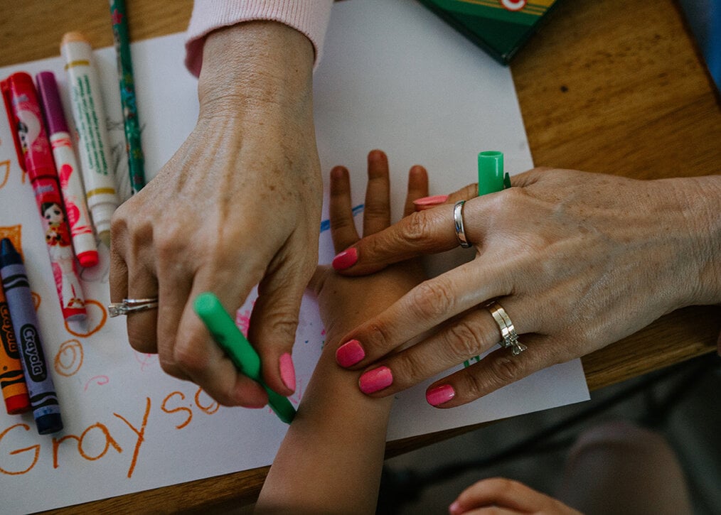 A teacher tracing a students hand