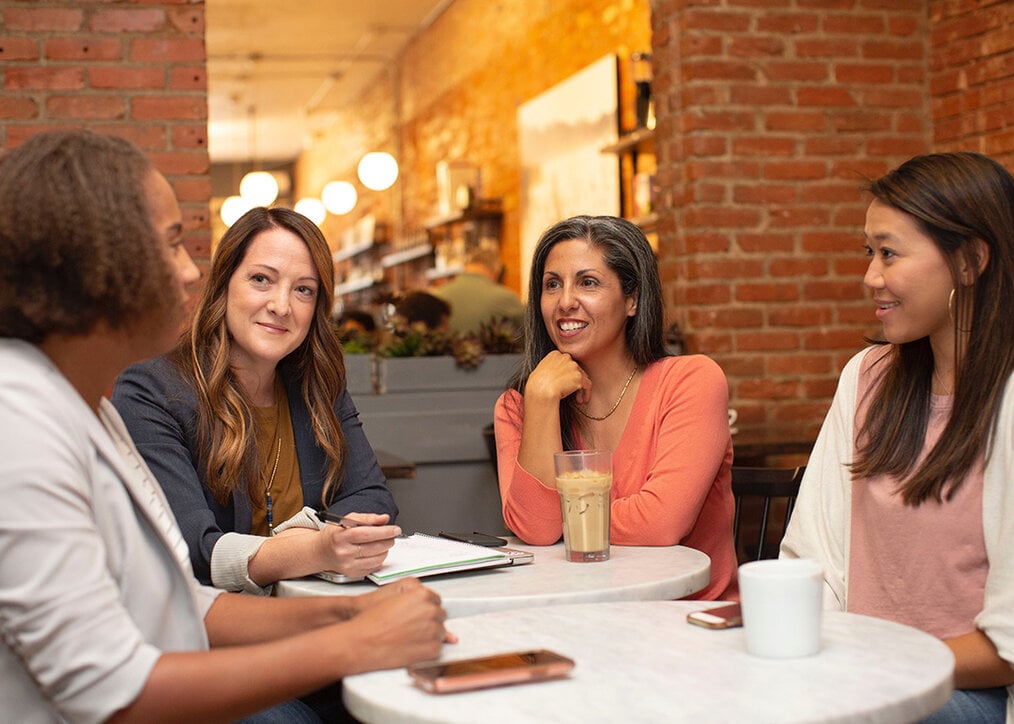 Photo via Unsplash A group of four people networking