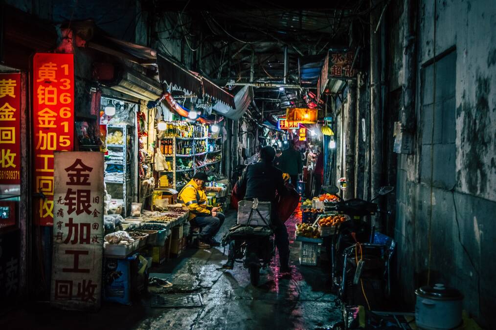 A night market in China with neon signs.