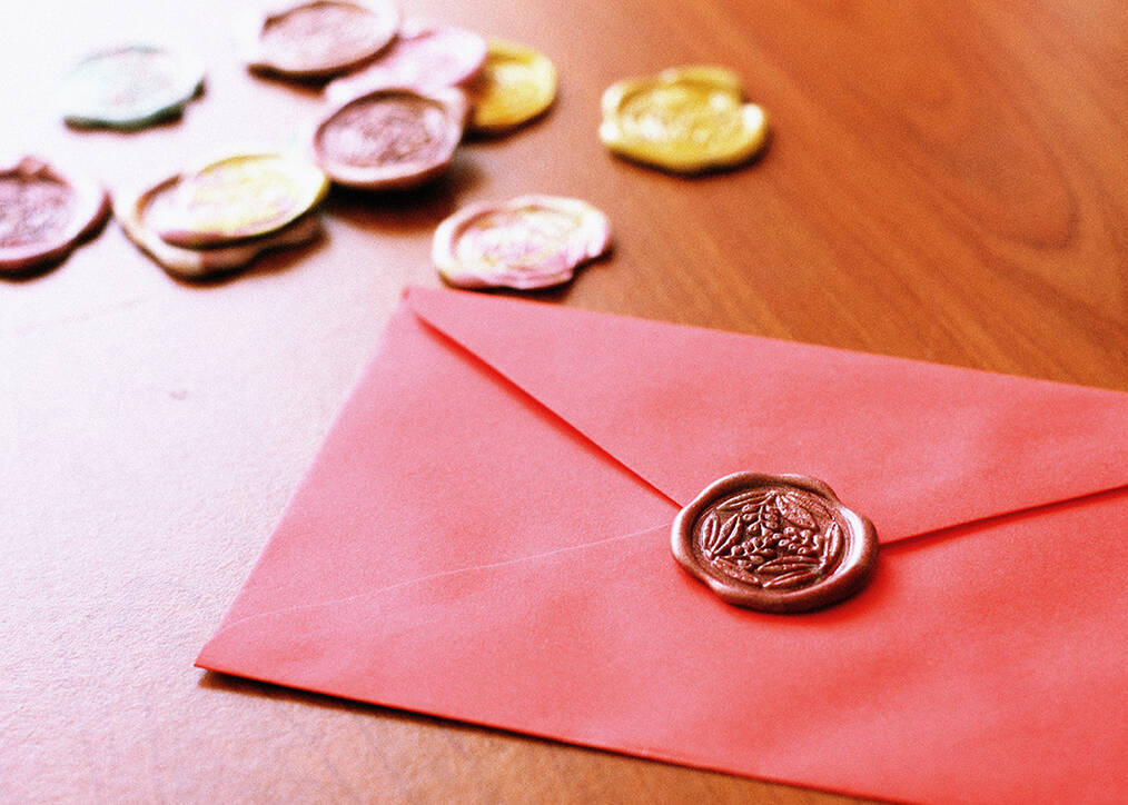 a red envelope with a wax stamp