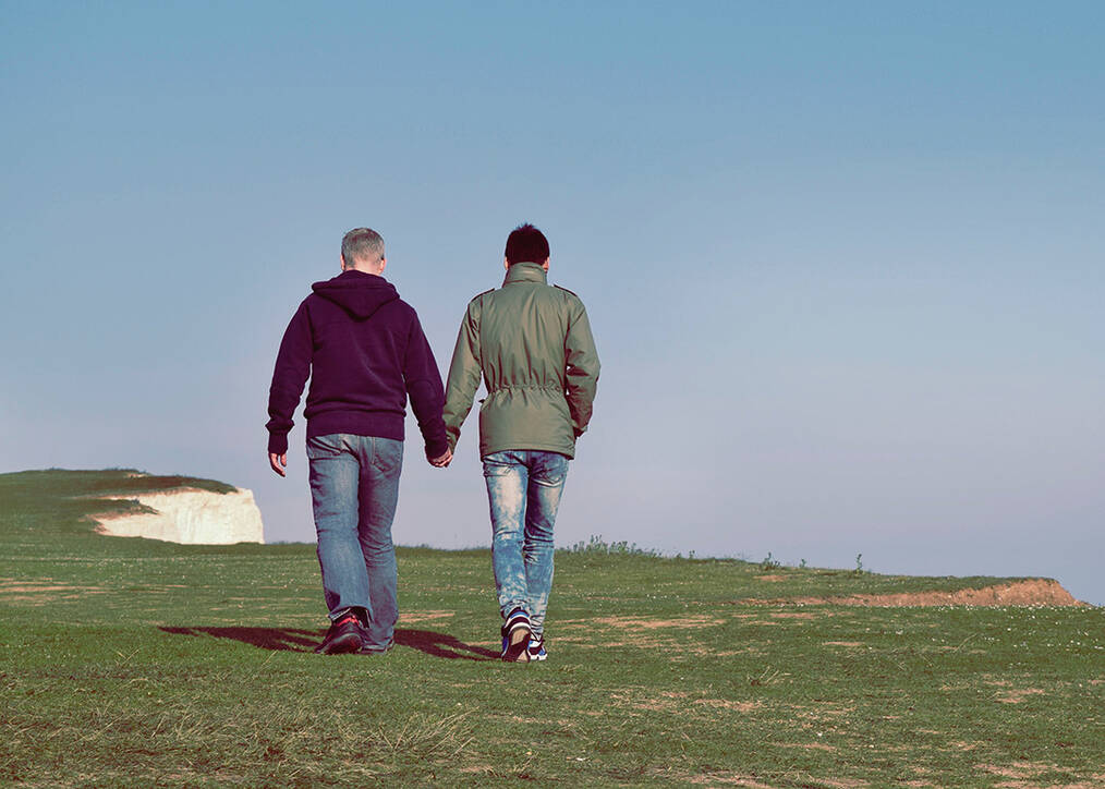 A couple holding hands while walking