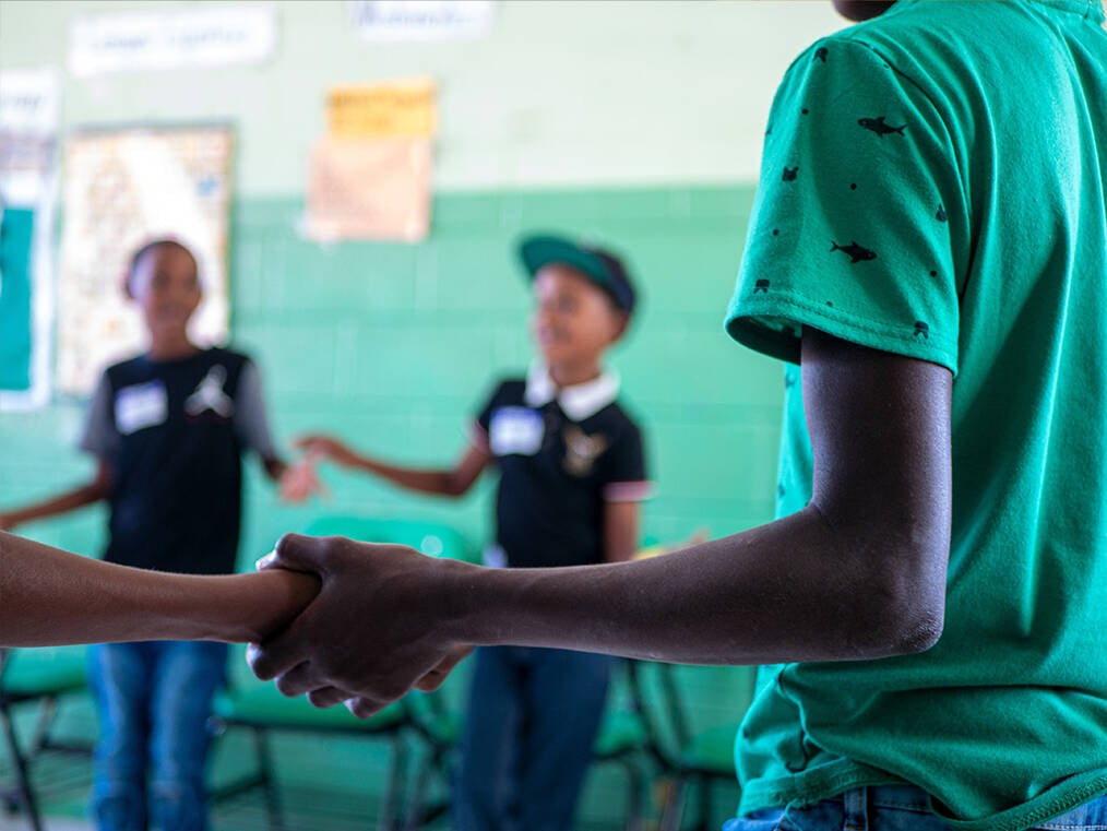 A group of students standing in a circle playing games