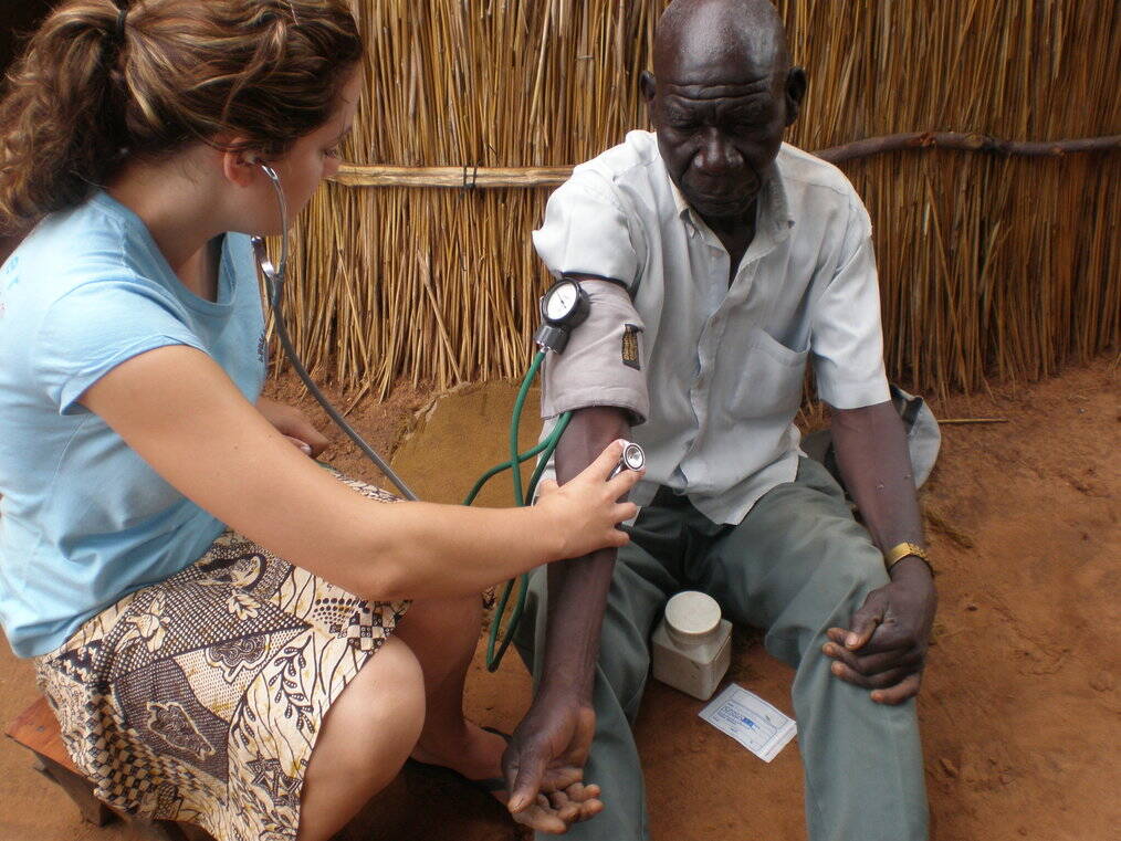 A woman takes a man's blood pressure.