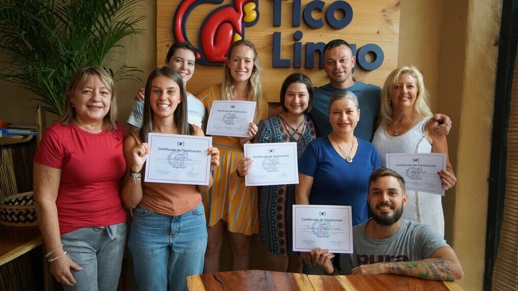 Tico Lingo A smiling group hold up their certificates at Tico Lingo center.