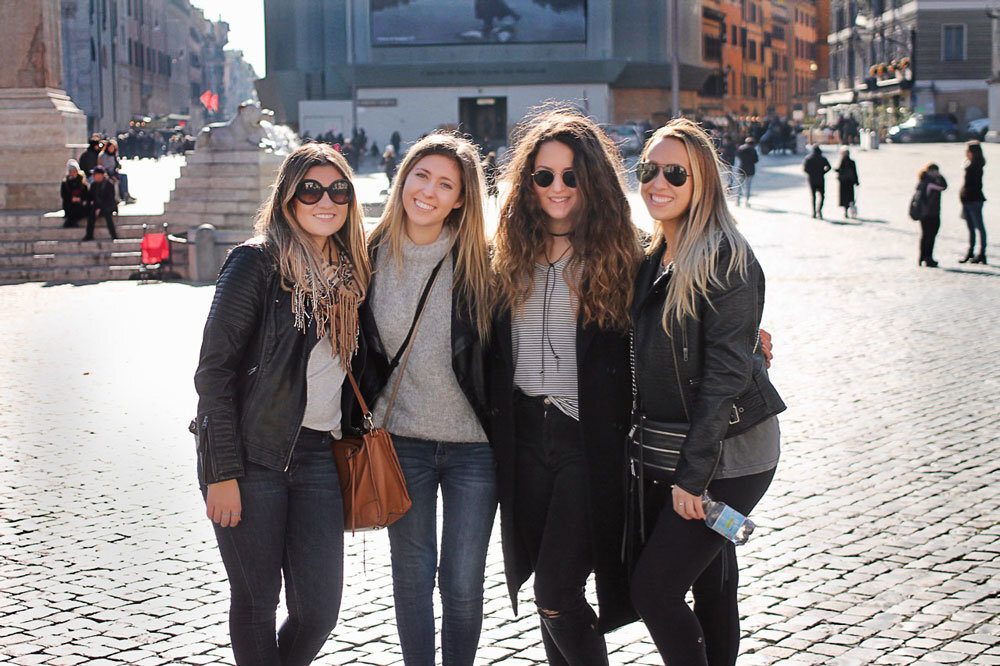 CEA Four women stand and smile for the camera.