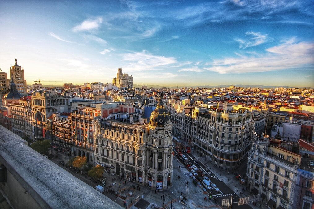 Photo by Jorge Fernández Salas on Unsplash A drone shot showing the buildings along Gran Via in Madrid, Spain.