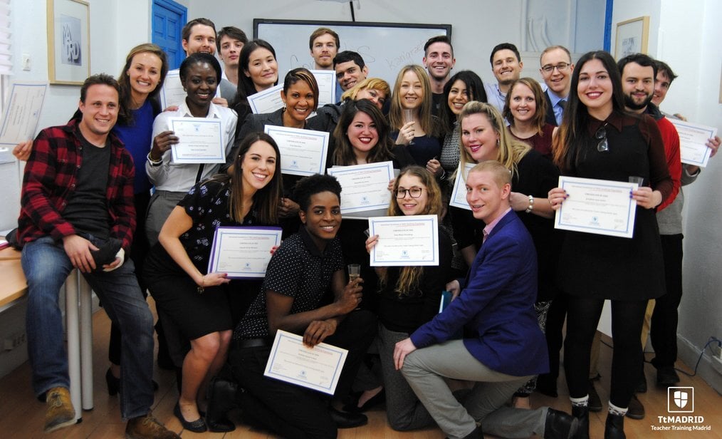TtMadrid A group of people hold TEFL certificates.