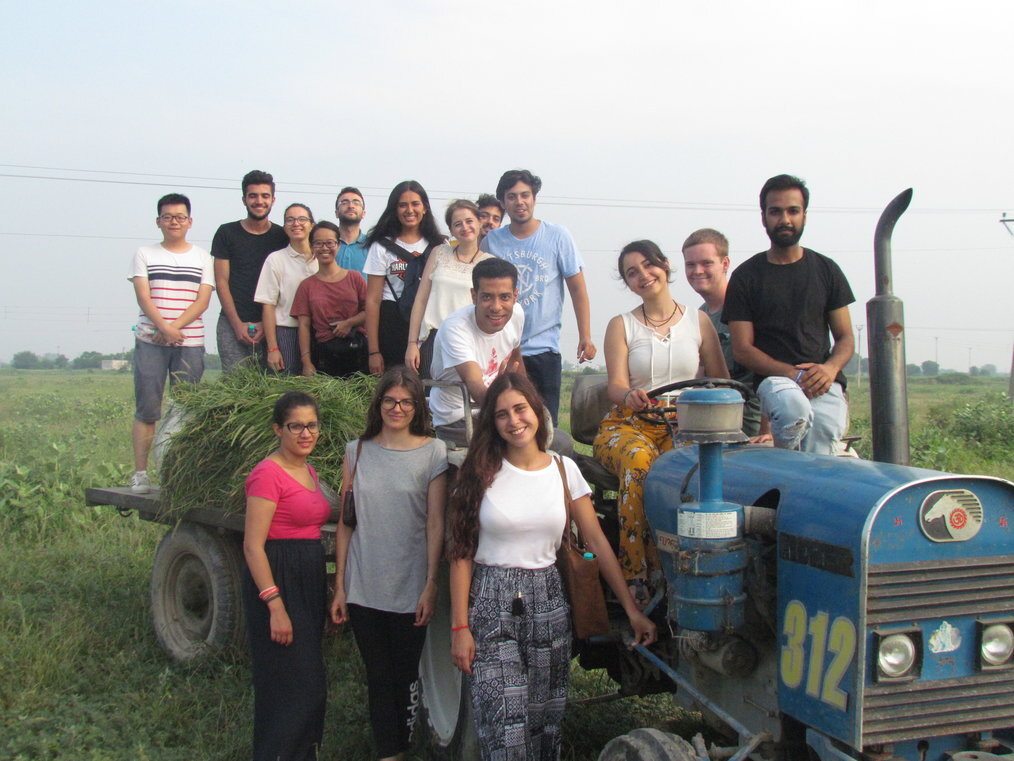TTW A group of young people pose smiling on a tractor in India.