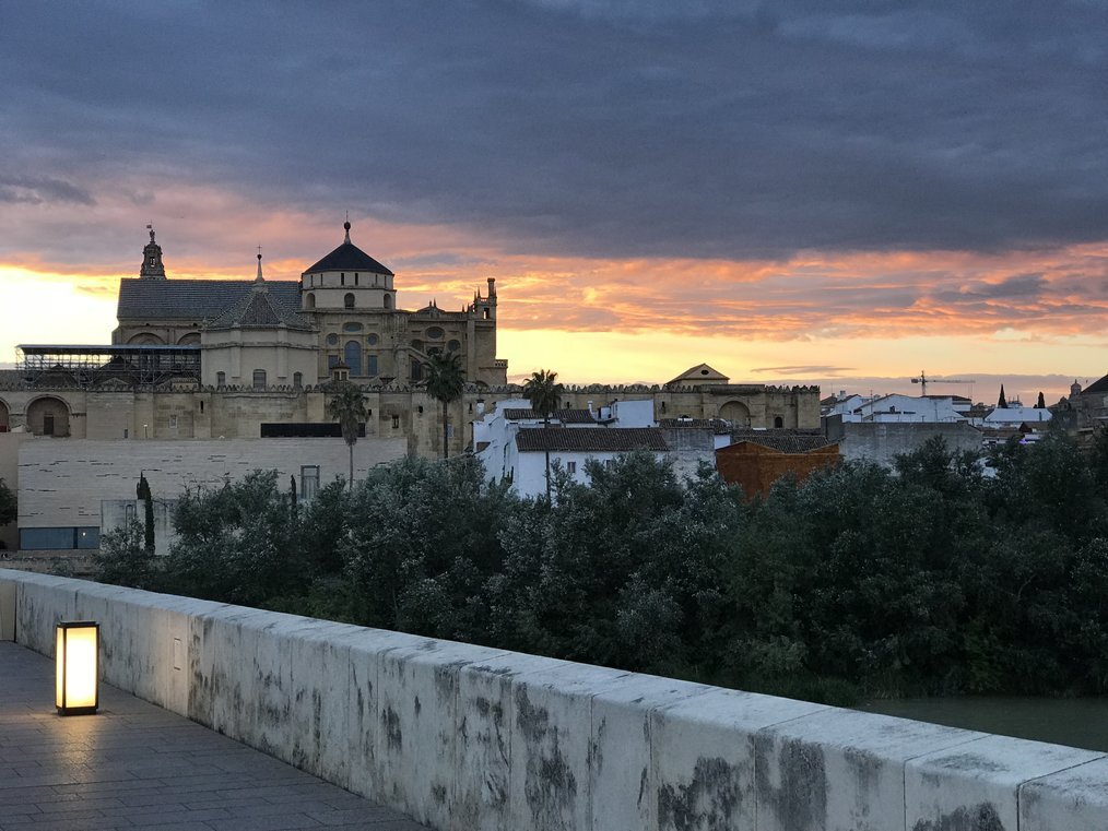 TH A sunset over a historic building in Madrid.